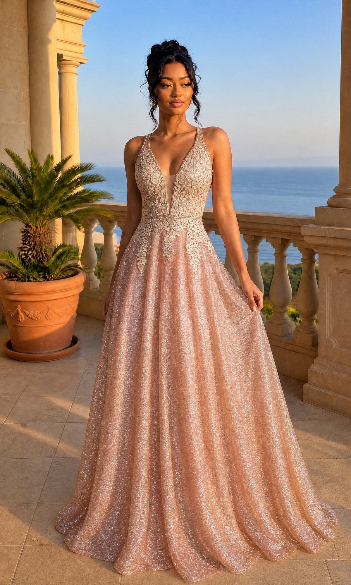 A woman in the rose gold Chicas C2425 long prom dress with an A-line skirt and deep V-neckline stands on a balcony overlooking the sea and greenery, surrounded by potted plants.
